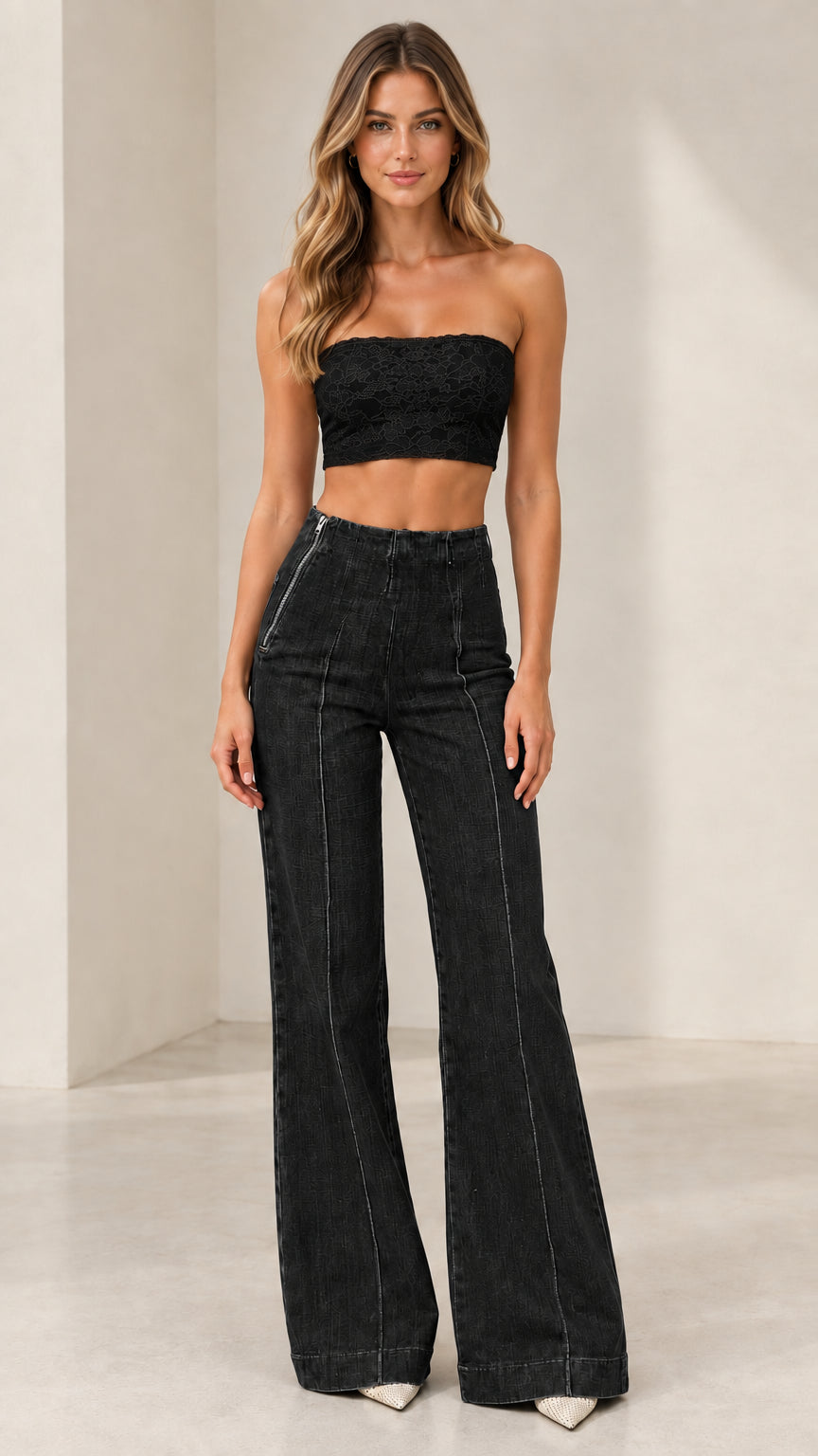 Model wearing Washed Black high-rise seamed flare jeans with black crop top