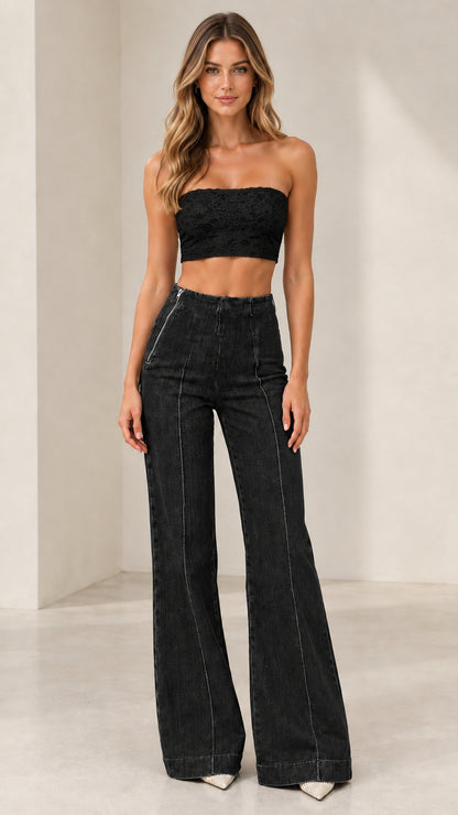 Model wearing Washed Black high-rise seamed flare jeans with black crop top