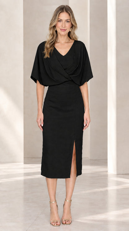 Front view of model wearing black draped flutter sleeve midi sheath dress