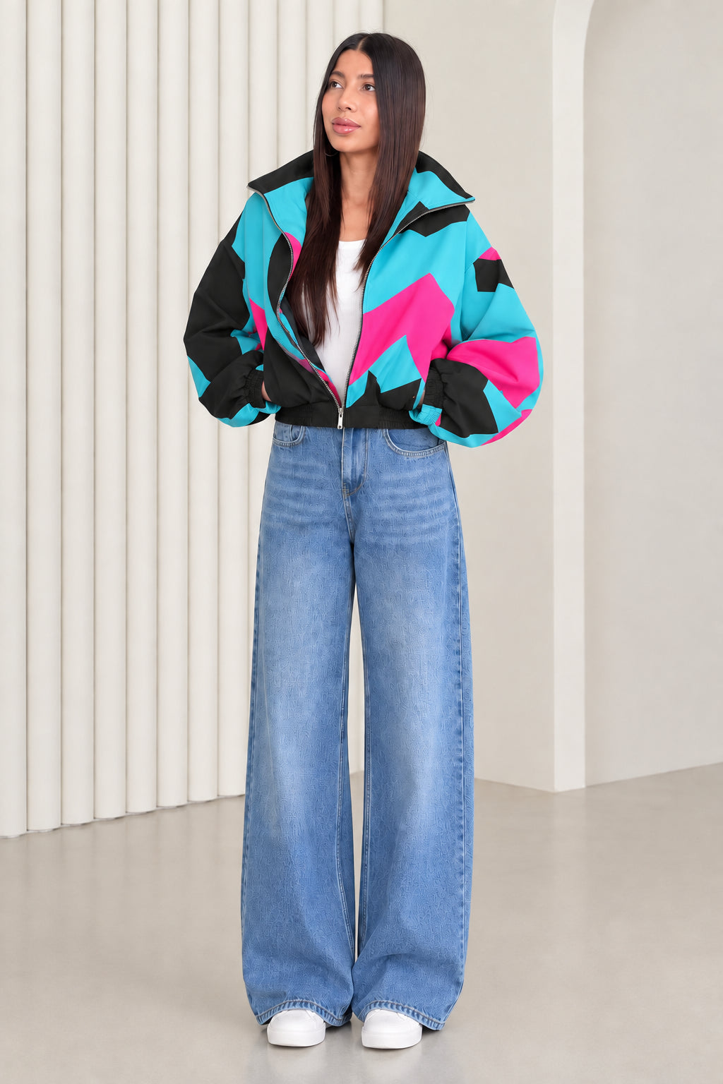 Woman wearing black and turquoise contrast colorblock retro windbreaker jacket