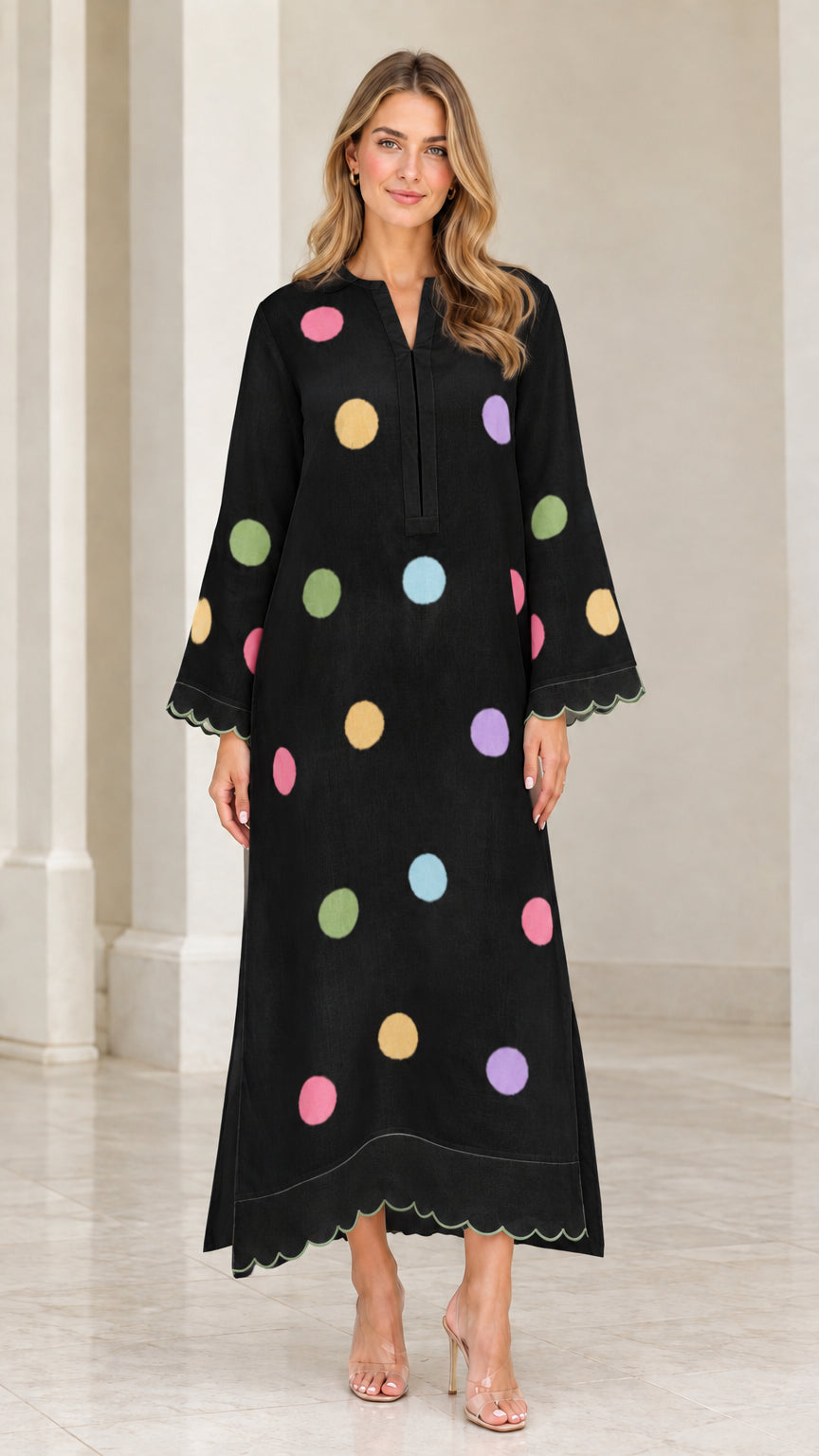 Woman wearing black polka dot long sleeve maxi kaftan dress