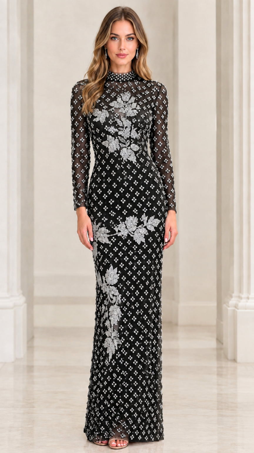 Front view of black beaded long sleeve evening gown with silver floral accents