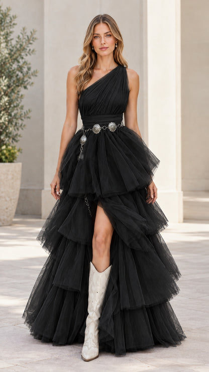 Model wearing black one-shoulder tiered tulle maxi dress with slit