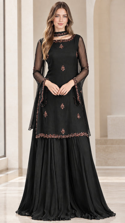 Model wearing black embellished tunic and flowing pleated sharara set