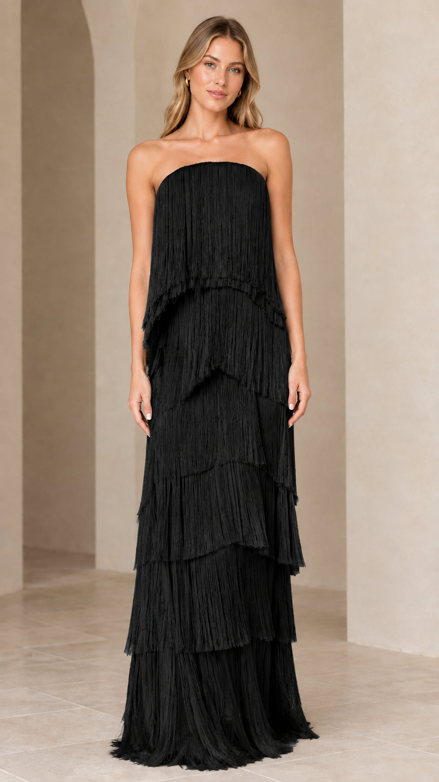 Full-length view of strapless tiered fringe maxi dress in black