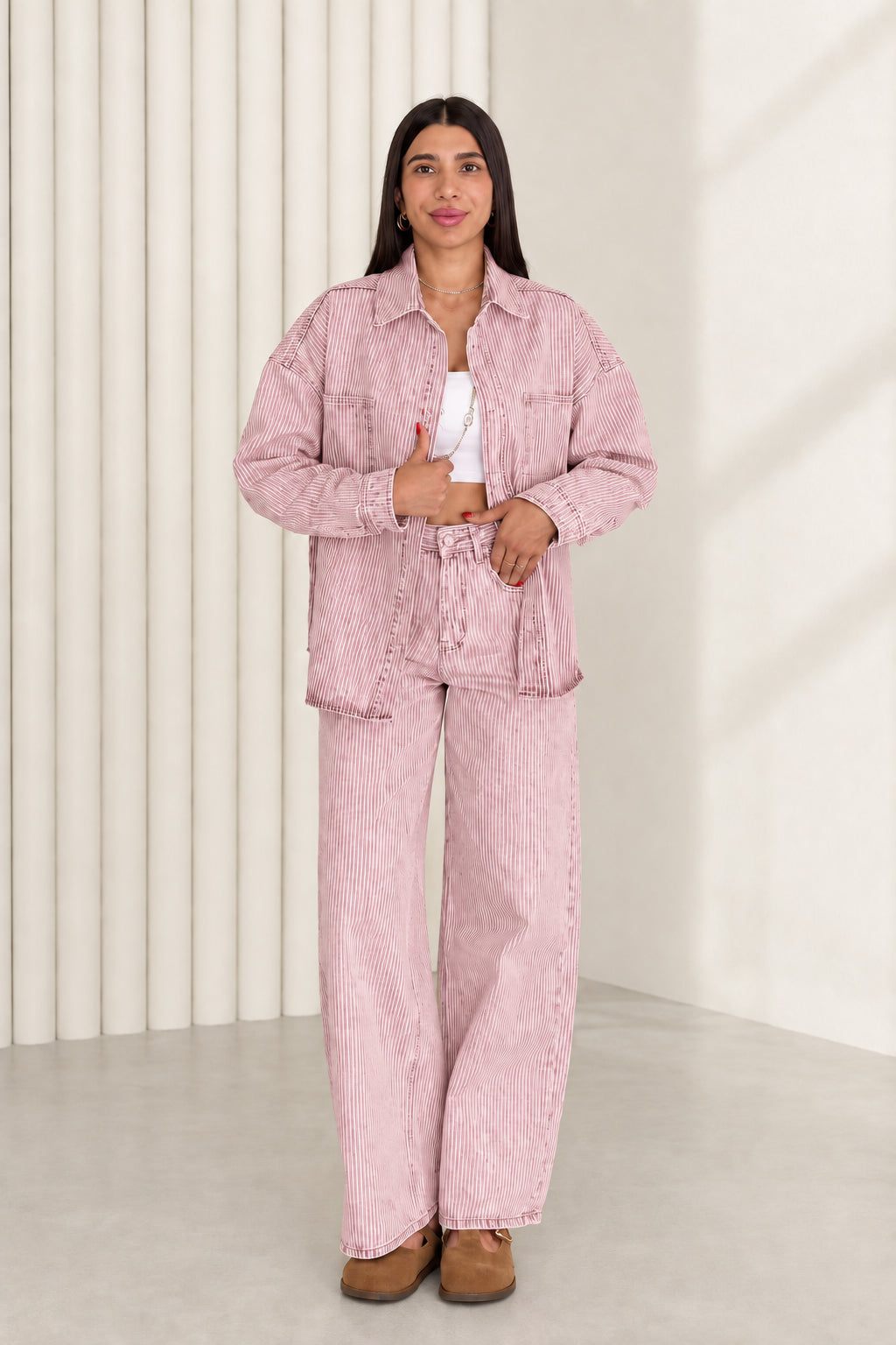 Model wearing dusty pink striped denim shacket and wide leg pants set