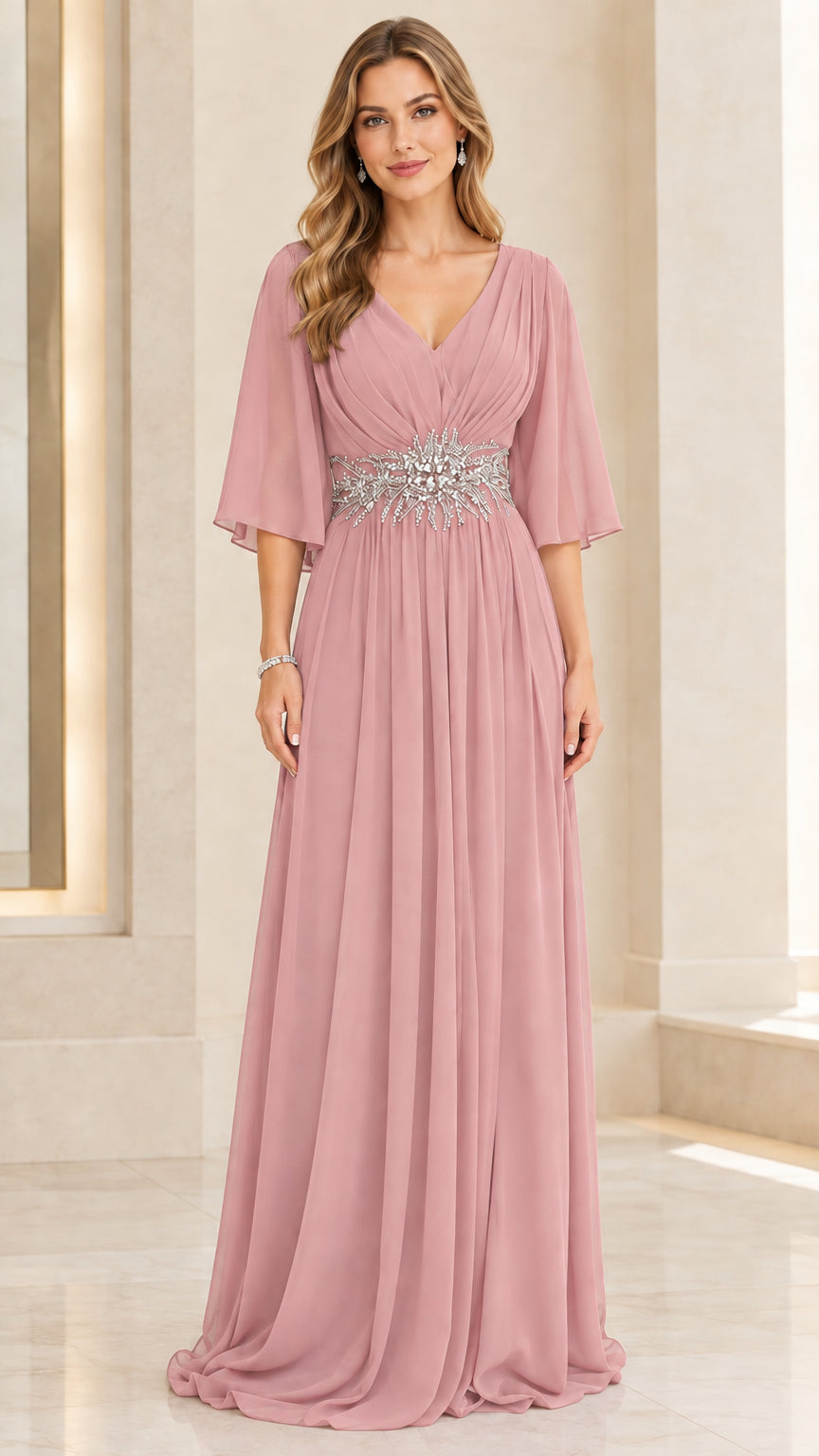 Woman wearing dusty rose pink pleated chiffon evening dress with embellished waist