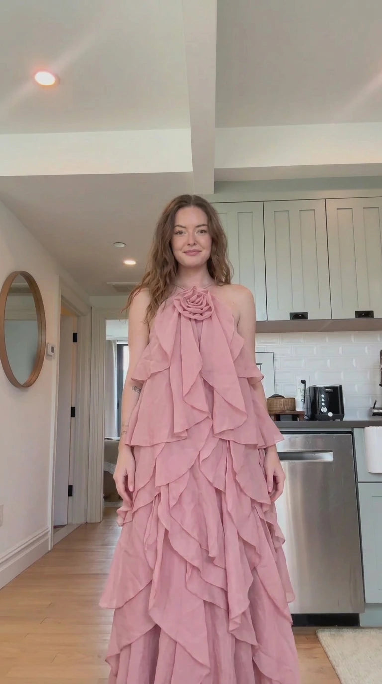 Front view of model wearing dusty pink tiered ruffle rosette maxi dress