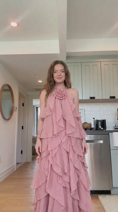 Front view of model wearing dusty pink tiered ruffle rosette maxi dress