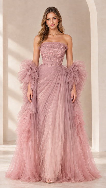 Full-length view of dusty pink strapless beaded tulle evening gown with ruffled sleeve wraps
