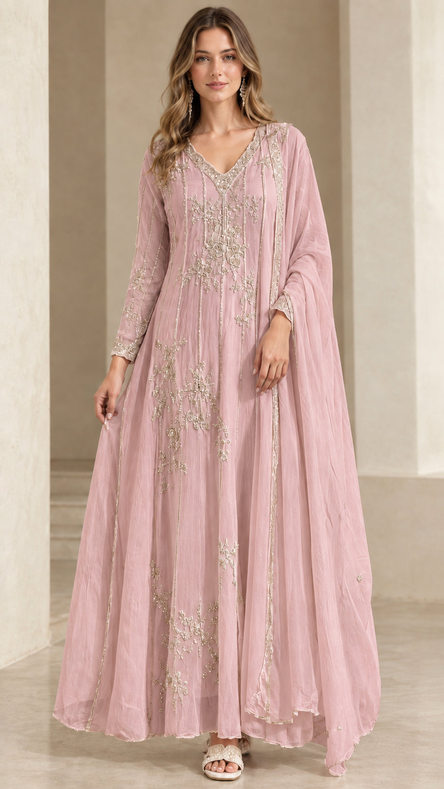 Model wearing blush pink embroidered A-line evening dress with matching drape
