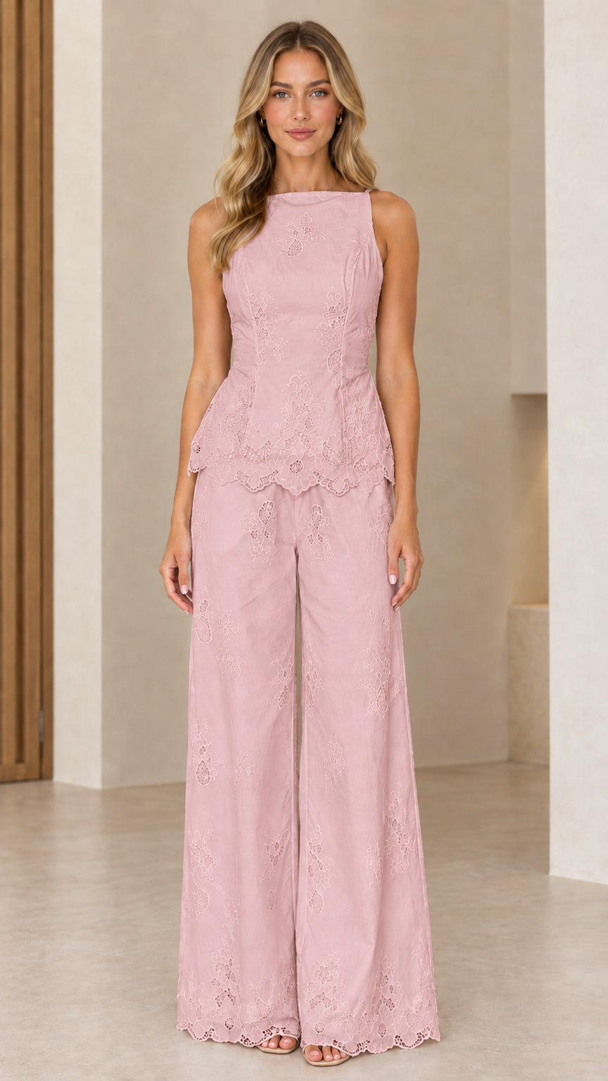 Full length view of model wearing blush pink embroidered peplum two-piece set