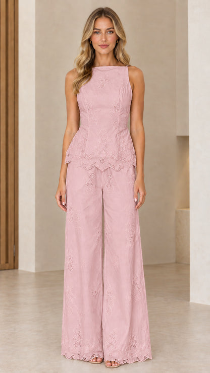 Full length view of model wearing blush pink embroidered peplum two-piece set