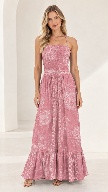 Full-length front view of dusty pink printed smocked tiered maxi dress