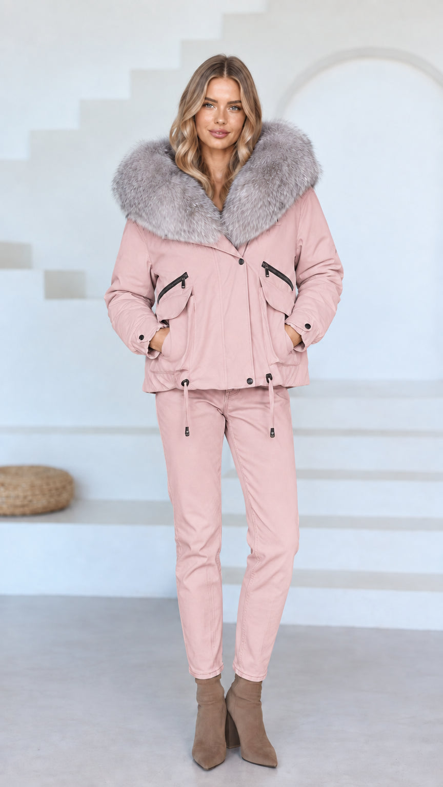 Front view of model wearing dusty pink faux fur hooded jacket and matching pink pants