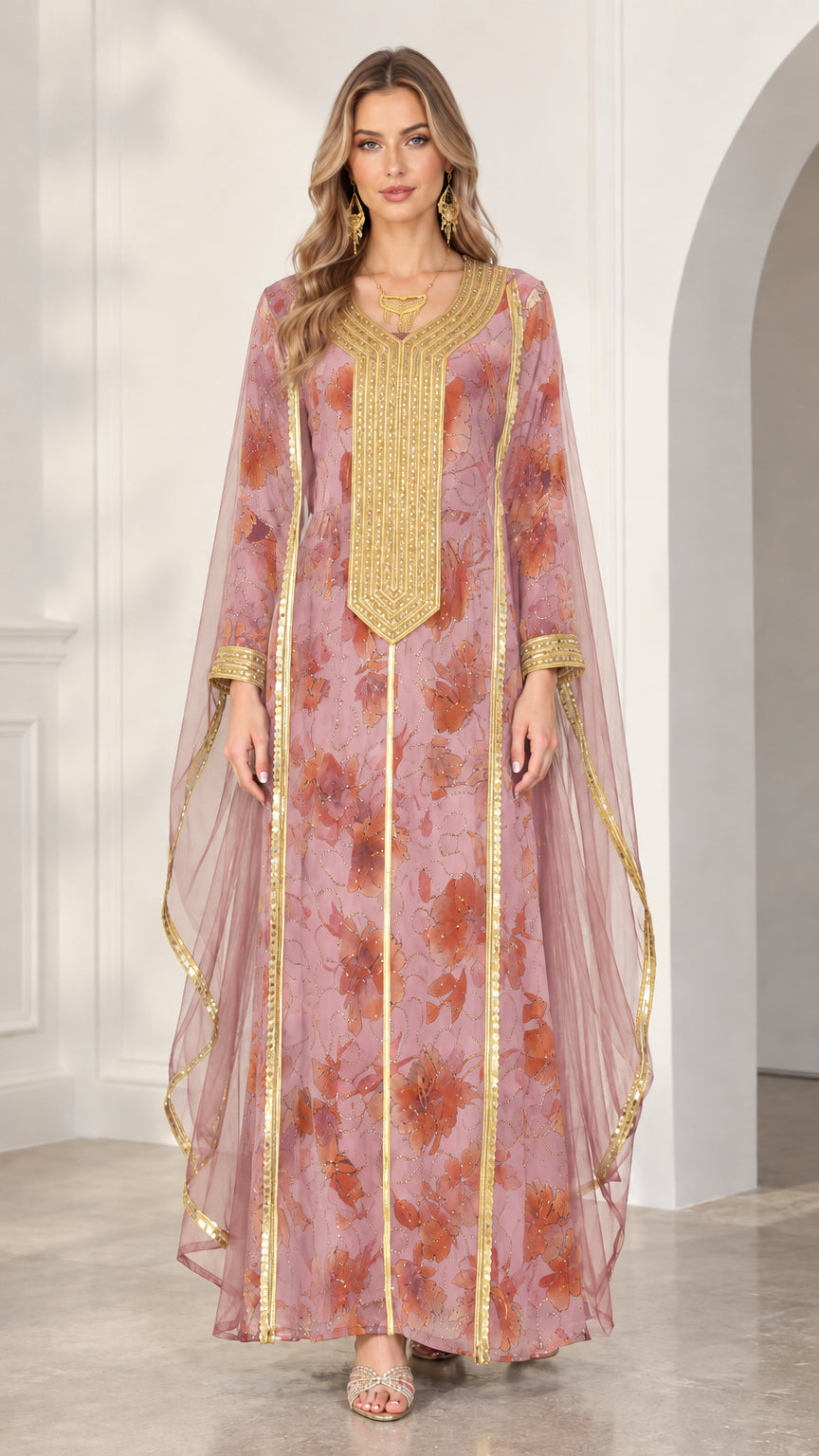 Model wearing dusty pink floral kaftan dress with gold embroidery and sheer side cape
