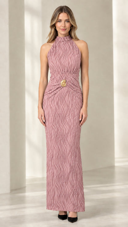 Front view of woman wearing mauve pink textured halter neck maxi dress