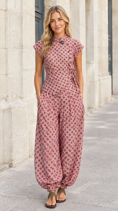 Front view of woman wearing dusty pink geometric print 2-piece top and harem pants set