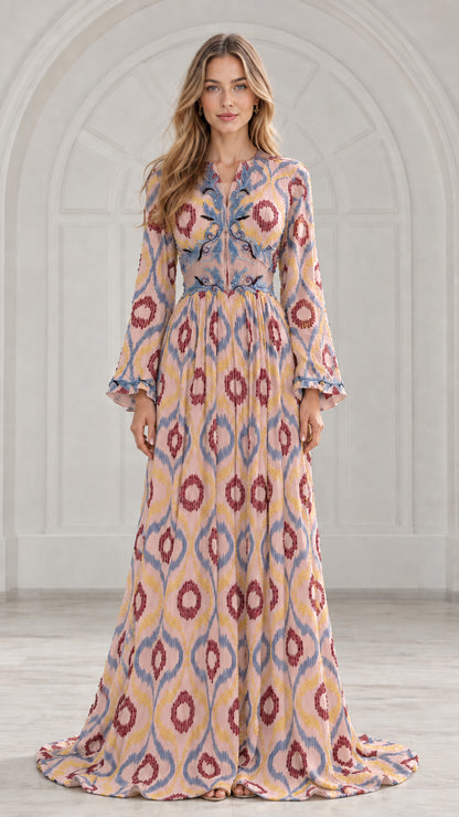 Front view of model wearing blush pink ikat print pleated maxi dress