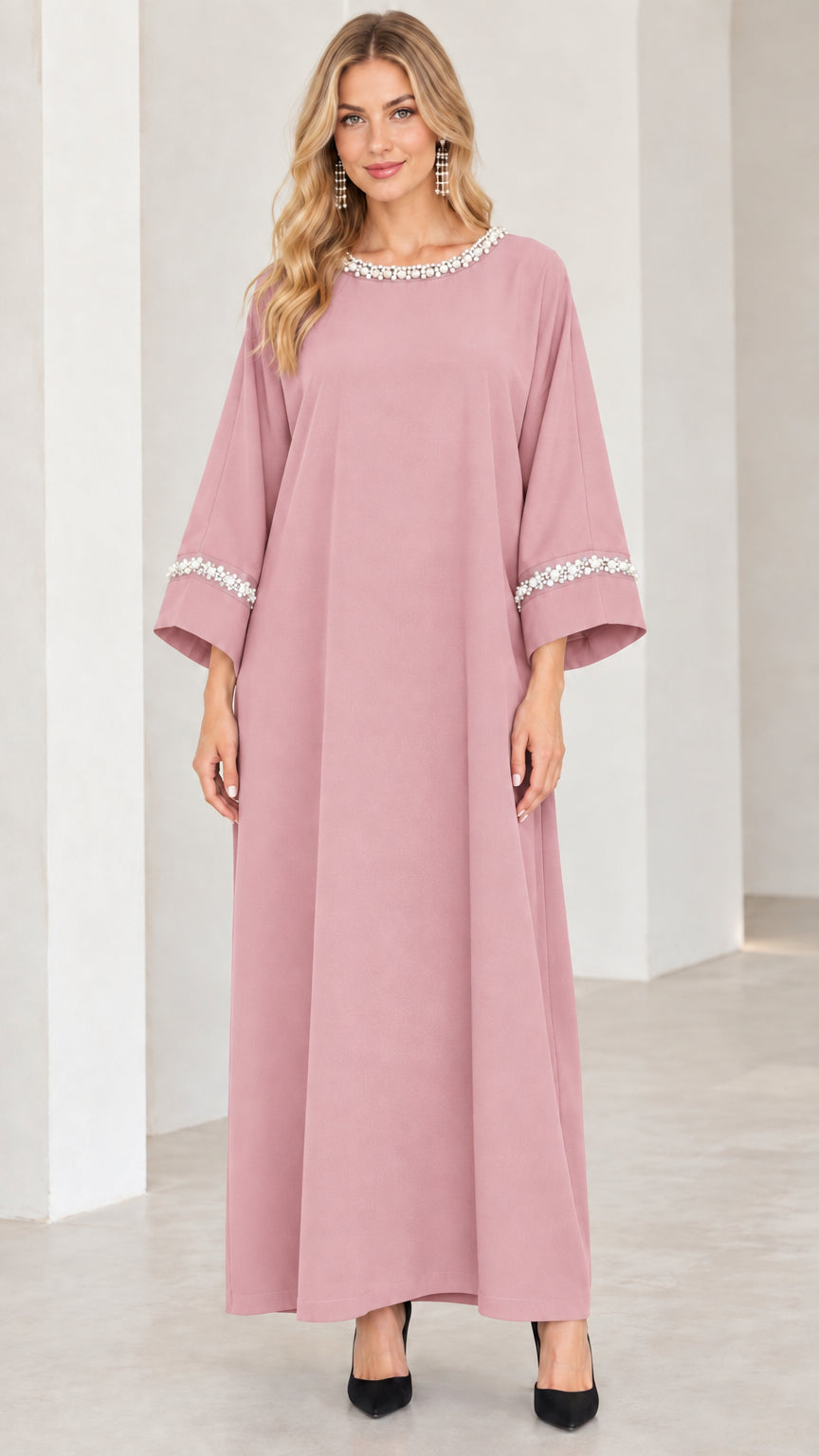 Front view of woman wearing dusty pink pearl-trimmed maxi dress