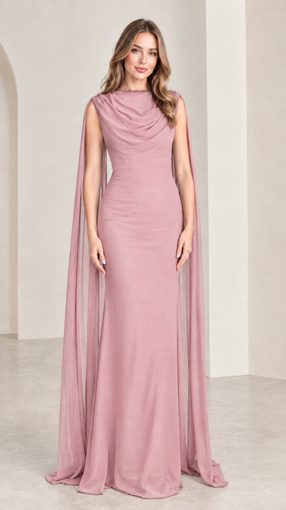 Model wearing soft dusty rose pink cape sleeve formal maxi dress