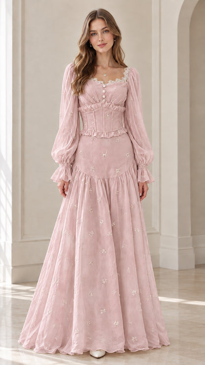 Front view of model wearing blush pink embroidered corset maxi dress