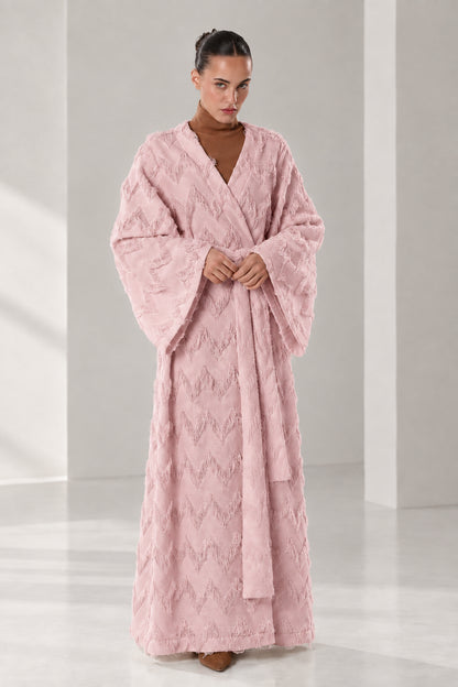 Front full view of woman wearing dusty pink textured chevron fringe maxi wrap robe