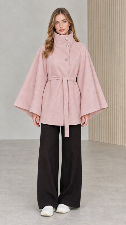 Front view of model wearing dusty pink high neck belted cape coat