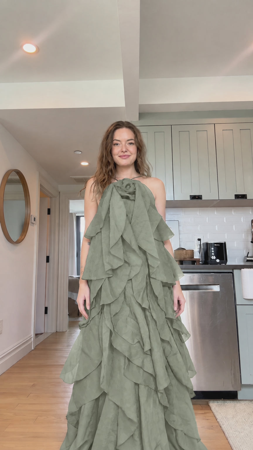 Front view of model wearing sage green tiered ruffle rosette maxi dress