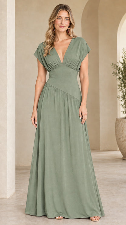 Model wearing sage green cap sleeve asymmetrical drop waist dress