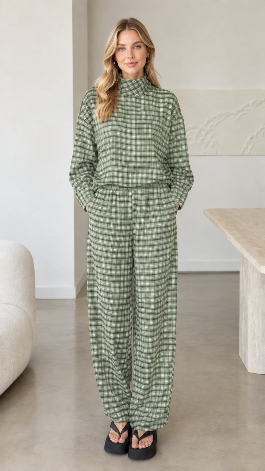 Front view of woman wearing sage green plaid mock neck top and wide leg pants set