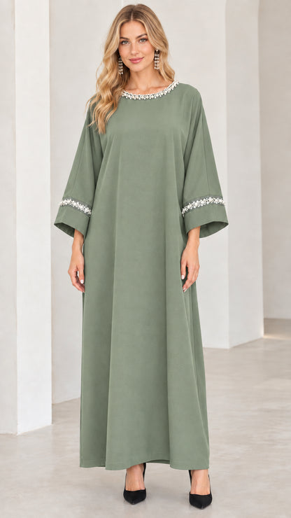 Front view of woman wearing sage green pearl-embellished modest maxi dress