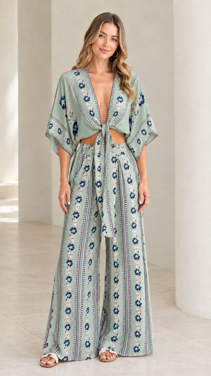 Model wearing sage green floral stripe two-piece crop top and wide-leg pants set