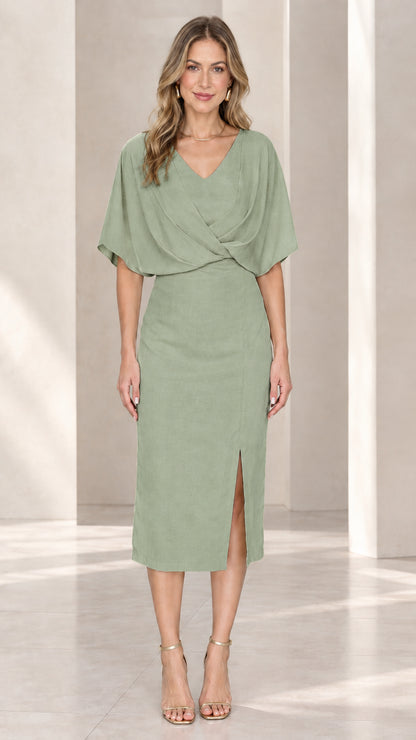 Front view of model wearing sage green crossover v-neck midi sheath dress