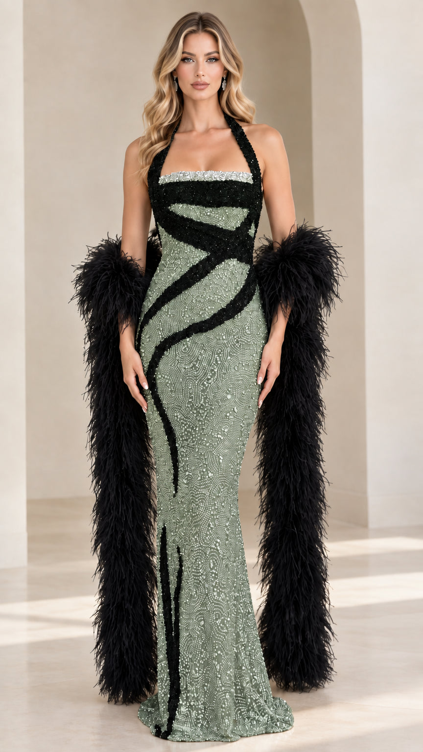 Model wearing sage green halter sequin mermaid dress with black swirl accents