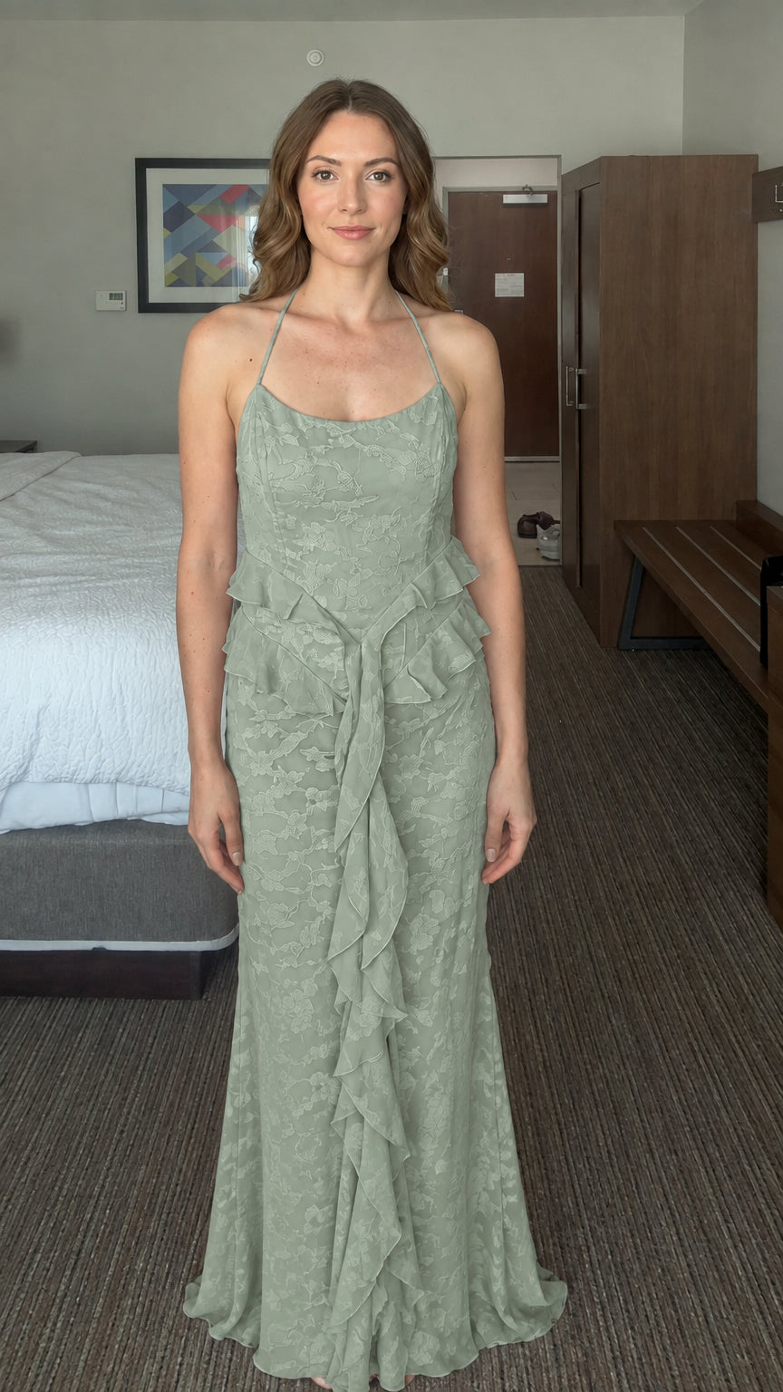 Front view of woman wearing sage green floral jacquard halter maxi dress