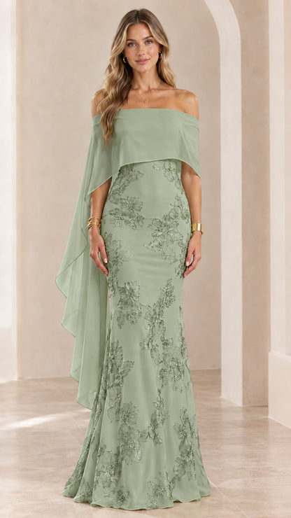 Woman wearing sage green off-the-shoulder embroidered cape evening gown