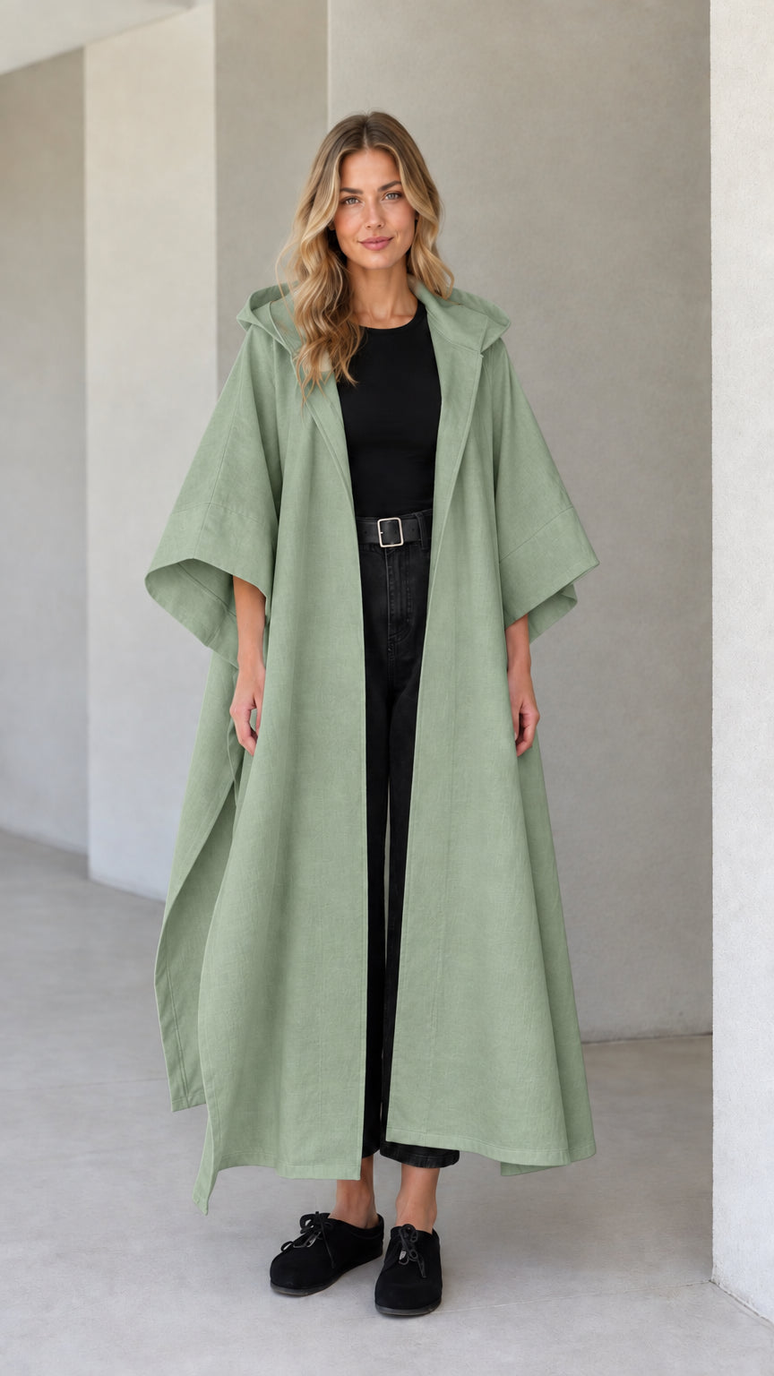 Model wearing sage green hooded maxi canvas cape coat