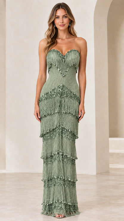 Front view of woman wearing sage green strapless tiered fringe evening gown