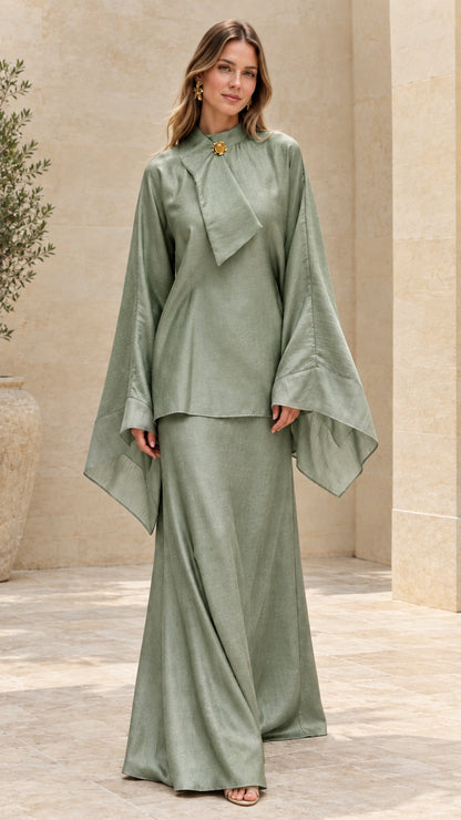 Model wearing sage green elegant draped tunic top and maxi skirt set