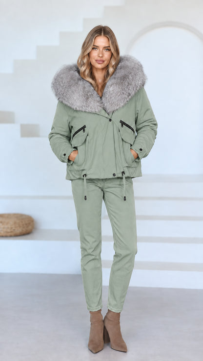 Front view of model wearing sage green faux fur hooded jacket and matching green pants