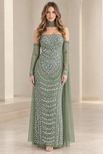 Model wearing sage green beaded strapless evening gown with flowing cape sleeves
