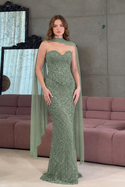 Full-length front view of the embellished strapless evening gown in elegant sage green with flowing cape