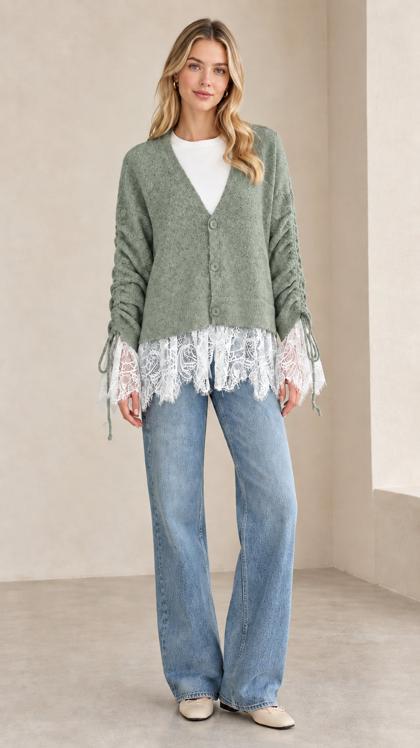 Front view of woman wearing sage green V-neck lace-trimmed knit cardigan