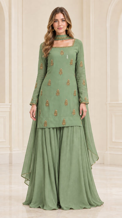 Model wearing sage green embroidered kurta sharara suit set
