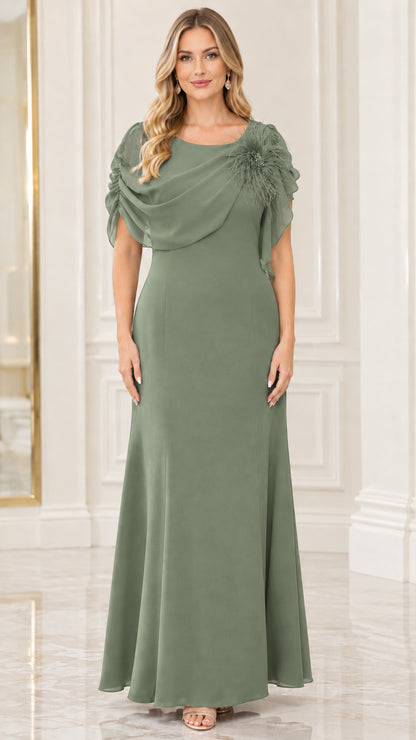 Model wearing sage green draped chiffon evening gown with shoulder flower