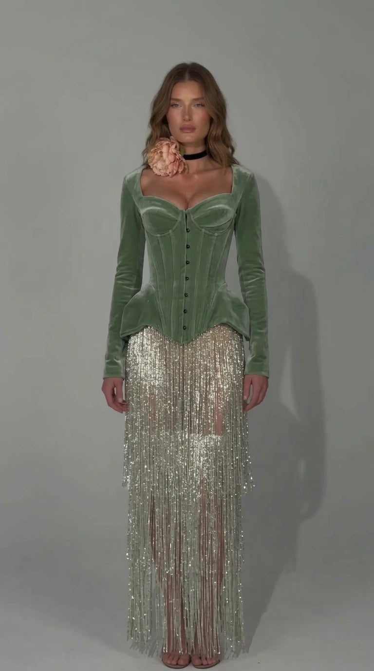 Front view of sage green velvet corset dress with shimmering fringe overlay