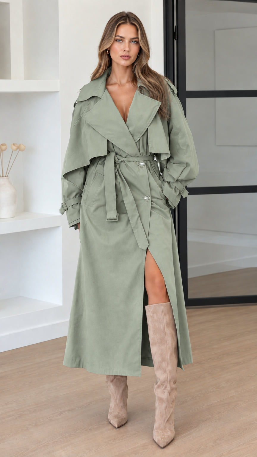 Front view of woman wearing Sage Green oversized maxi trench coat with belt