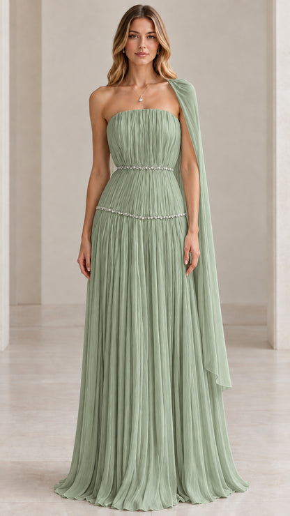 Model wearing sage green strapless pleated evening gown with flowing drape
