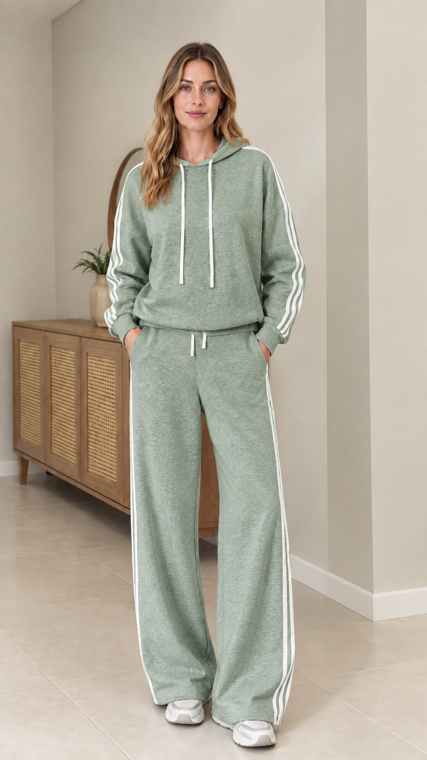 Model wearing Sage Green two-piece tracksuit set with white side stripes